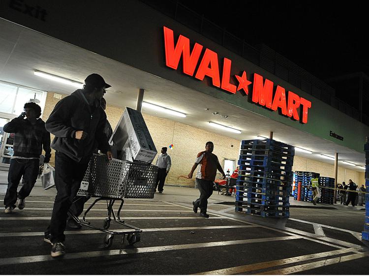 Shoppers wheel their purchases out of a Wal-Mart store in Los Angeles, California. (Robyn Beck/AFP/Getty Images)