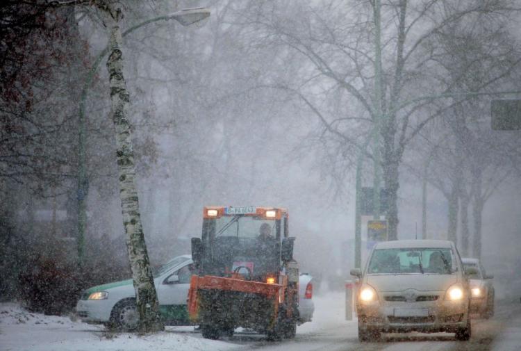 Cars and a snow remover crawl through a thick snowfall in Zehlendorf district. Arctic temperatures and heavy snow have caused numerous deaths and brought public transit to a halt across Europe. (Sean Gallup/Getty Images)