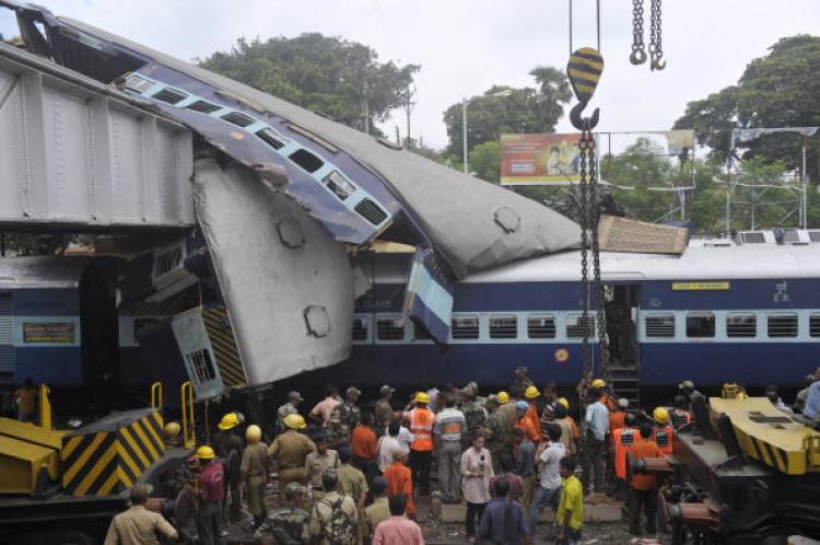 West Bengal Train Crash: Indian rescue personnel conduct recovery operations on the mangled wreckage of train coaches following a railway accident in Sainthia, some 260 kms north of from Kolkata, on July 19. (Deshakalyan Chowdhury/AFP/Getty Images)