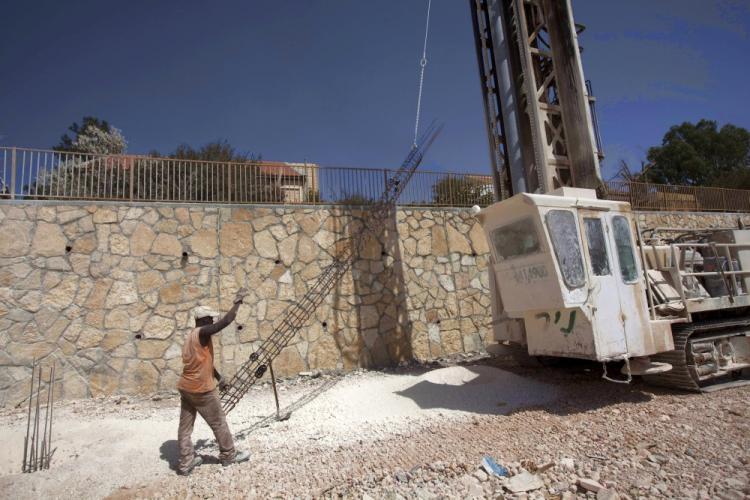 A worker prepares foundation for a new house on September 27, 2010 in the West Bank settlement of Kokhav Hashahar as Israel ended its 10-month settlement freeze in the West Bank. (Menahem Kahana/AFP/Getty Images)