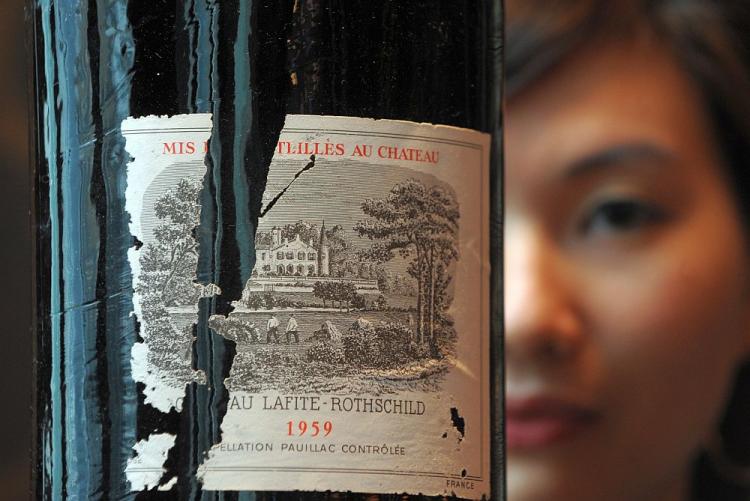 A model shows a bottle of a bottle of Chateau Lafite Rothschild (about US$20-30,000) at an auction preview in Hong Kong on January 28. Alarm bells are ringing over possible fraud involving Chinese wine. (Mike Clarke/AFP/Getty Images)