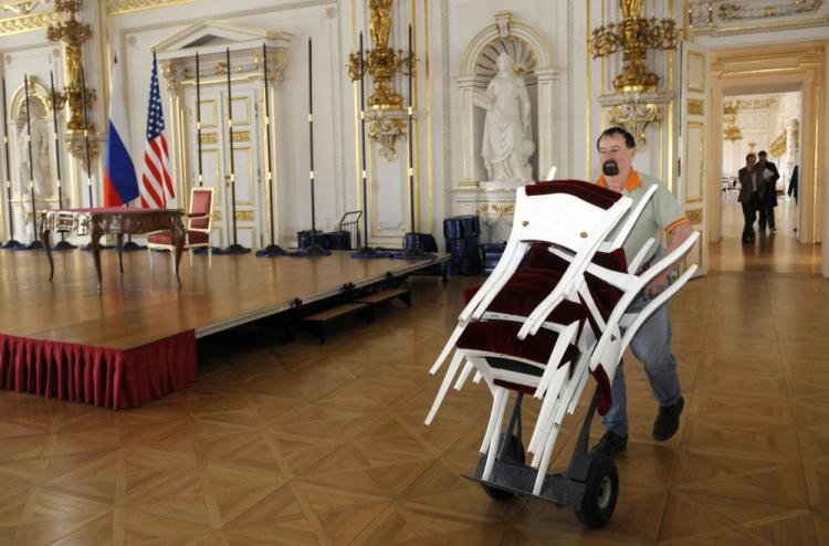 A worker carries chairs on April 6 in the Spain Hall at the Prague castle ahead of a meeting, set for April 8, with U.S. President Barack Obama and leaders of several former Soviet-bloc countries signing a nuclear disarmament treaty with Russia.  (Michal Cizek/AFP/Getty Images)
