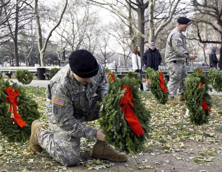 A soldier places a wreath in Battery Park in lower Manhattan on Saturday. December 11 is Wreaths Across America Day, a day to remember those that have died in service to the U.S. (Phoebe Zheng/The Epoch Times)