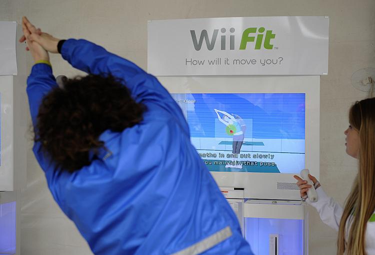 A woman tries the Wii Fit, Nintendo's latest extension to its popular Wii game console, during an event to mark the Wii Fit launch in New York, May 19, 2008.    (Emmanuel Dunand/AFP/Getty Images)