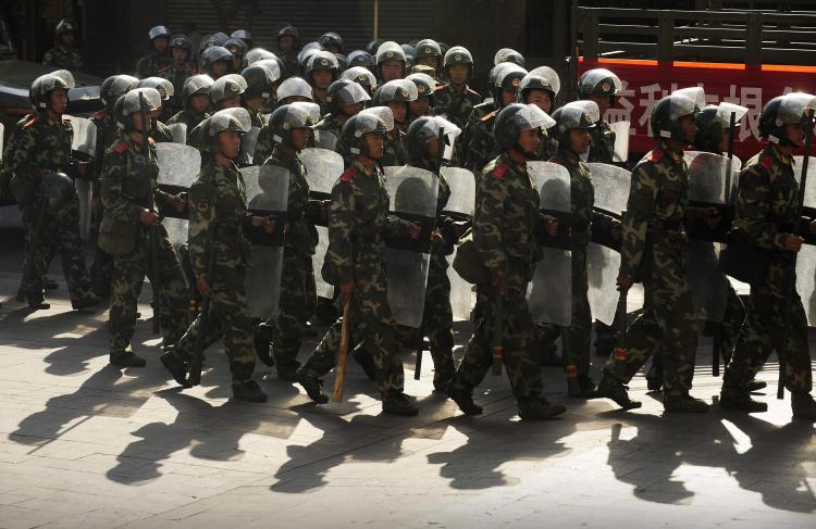 Chinese paramilitary police march through a street in Urumchi, in China's farwest Xinjiang region, on July 9, 2009. (Peter Parks/AFP/Getty Images)