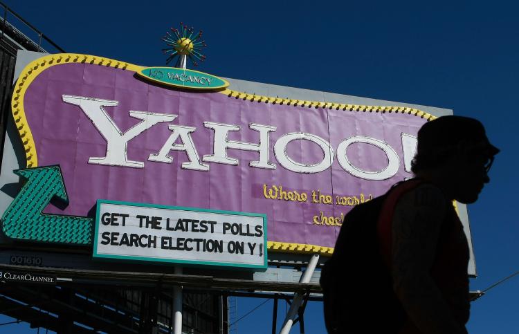A pedestrian walks by a Yahoo billboard October 21, 2008 in San Francisco, California. Yahoo reported a fourth-quarter loss of $303 million as CEO Jerry Yang exited after a tumultuous tenure as CEO. (Justin Sullivan/Getty Images)