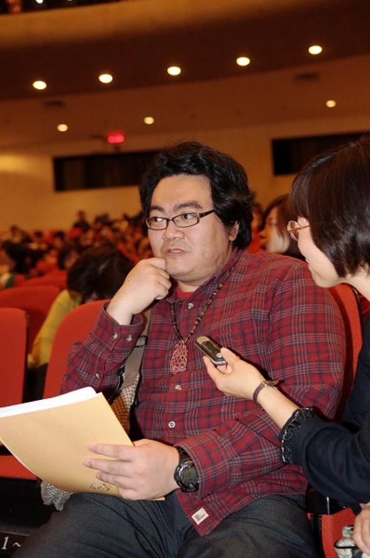 Tan Chongsyong, a vocalist, brings his grandmother along to watch Divine Performing Arts. (Yuan Li/The Epoch Times)