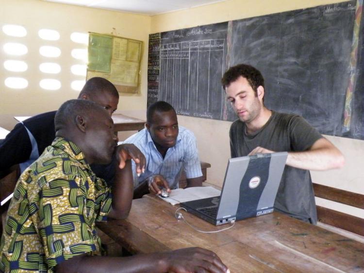 Amir Kaplan teaching Ivory Coast villagers to use computers for their first time. (Yuval Russek)