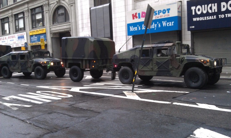 Approximately nine Humvees roll onto Broadway. The photo is taken between W. 26th and 27th streets at 5 p.m. Saturday. (Zack Stieber/The Epoch Times)