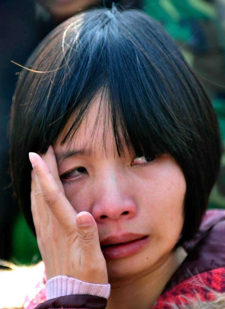 Zeng Jinyan, the wife of human rights activist Hu Jia weeps outside a courthouse after her husband was sentenced to three years jail in April this year.   (Teh Eng Koon/AFP/Getty Images)