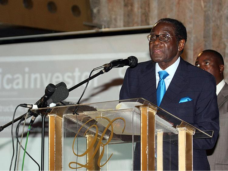 On March 1, a new law went into effect giving foreign companies worth at least $500,000 a time limit to transfer majority ownership to native black Zimbabweans. President Robert Mugabe seen here. (Jekesai Njikizana/AFP/Getty Images)