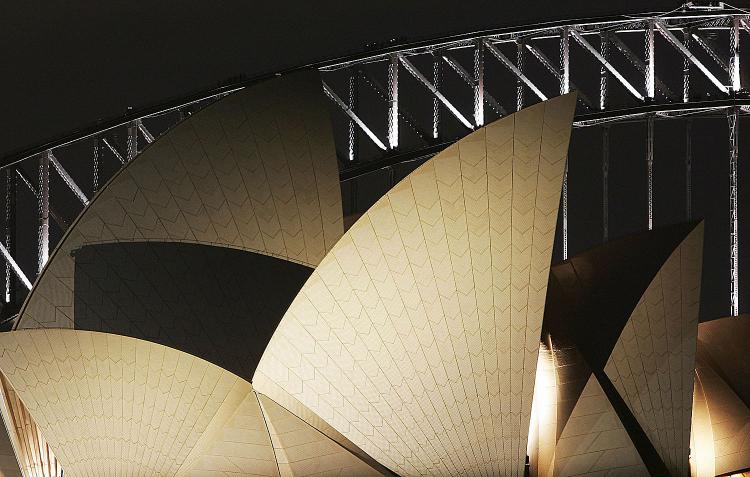 The Sydney Opera House and the Sydney Harbour Bridge illuminated.   (Ian Waldie/Getty Images)