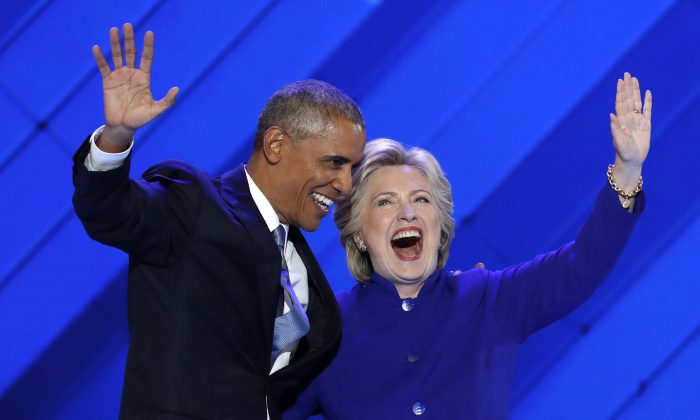 Barack Obama and Hillary Clinton wave to delegates after Obama's speech during the Democratic National Convention in Philadelphia, on July 27, 2016. (J. Scott Applewhite/AP Photo)