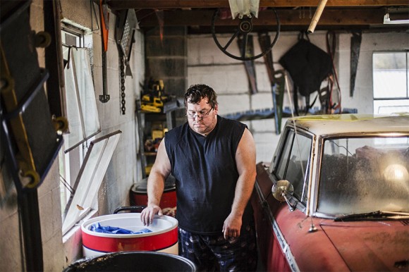 Eric Gilliam, an unemployed coal miner, in his garage at his home in Lynch, Ky., on Oct. 18, 2014. (AP Photo/David Goldman)