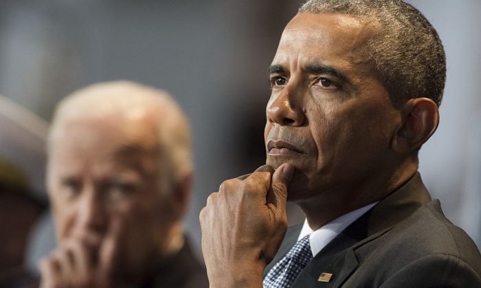 Then-President Barack Obama sits alongside then-Vice President Joe Biden at Joint Base Myers-Henderson Hall in Arlington, VA, on Jan. 4, 2017. (SAUL LOEB/AFP/Getty Images)