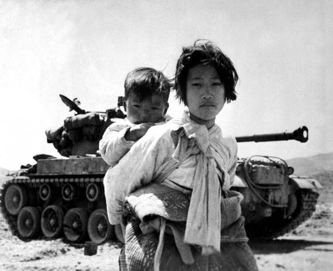 A Korean girl and her brother photographed during their flight from advancing communist forces during the Korean War. (Maj. R.V. Spencer/U.S. Navy)