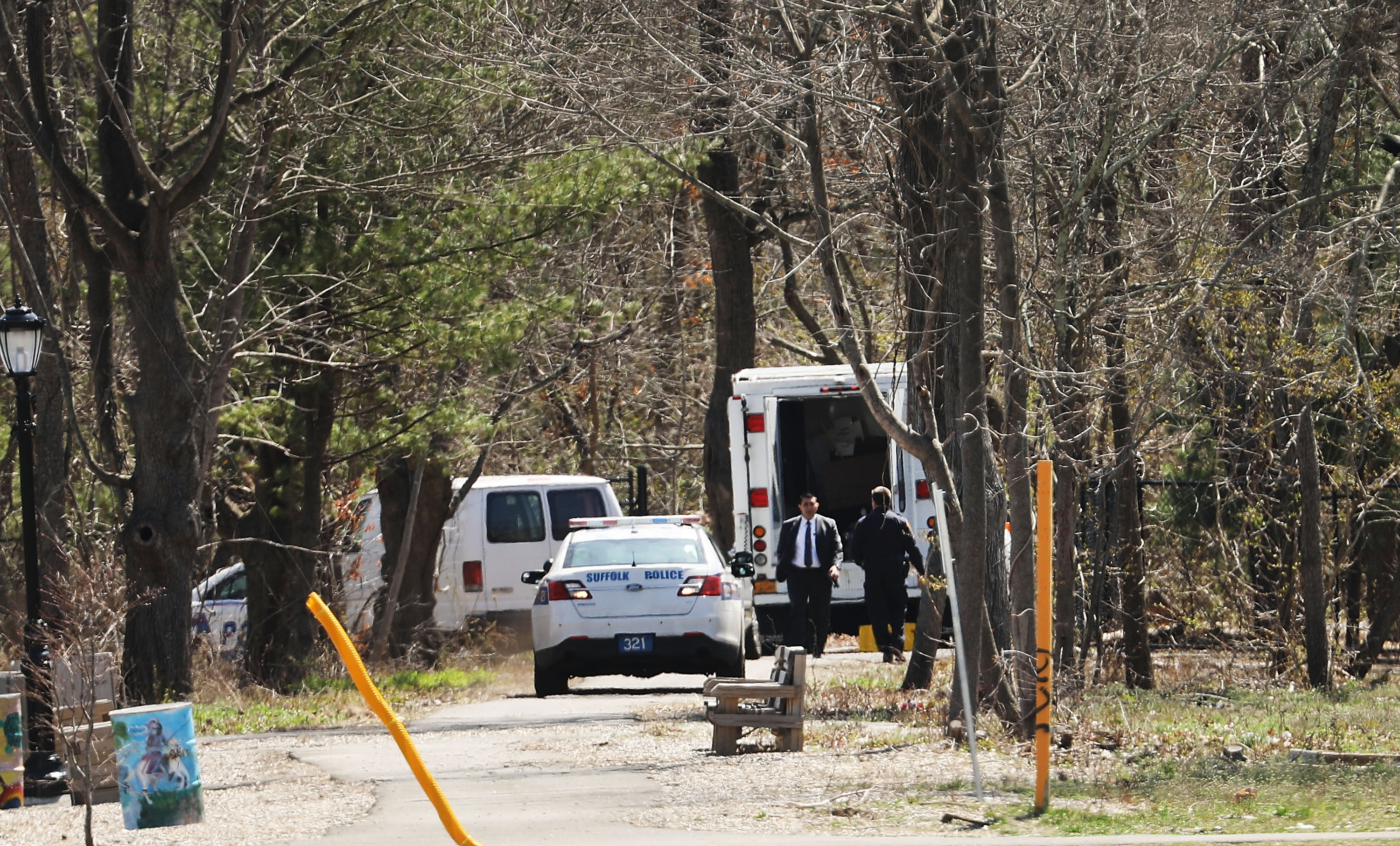 Police investigate the site where four young men were found murdered in a park in Central Islip, Long Island, on April 13. (Spencer Platt/Getty Images)