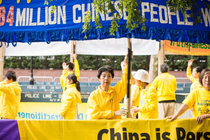 Falun Gong practitioners hold banners and perform exercises to raise awareness about the persecution inside China that is now in its 18th year at the Dag Hammarskjold Plaza near the United Nations headquarters in New York on Sept. 19, 2017. (Benjamin Chasteen/The Epoch Times)