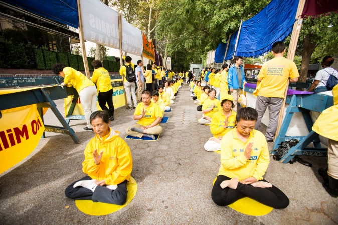 Falun Gong practitioners meditate to raise awareness about the persecution inside China that is now in its 18th year at the Dag Hammarskjold Plaza near the United Nations headquarters in New York while the world leaders meet on Sept. 19, 2017. (Benjamin Chasteen/The Epoch Times)