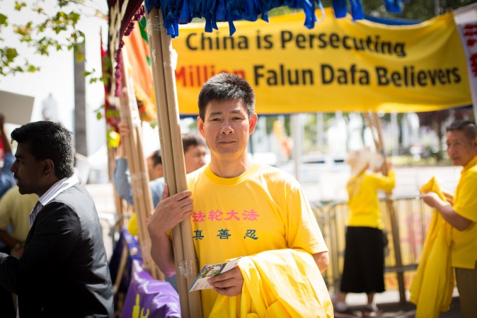 Falun Gong practitioners hold banners and perform exercises to raise awareness about the persecution inside China that is now in its 18th year at the Dag Hammarskjold Plaza near the United Nations headquarters in New York on Sept. 19, 2017. (Benjamin Chasteen/The Epoch Times)