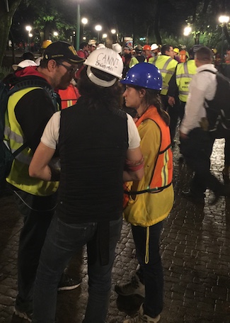 Volunteers in required safety wear discuss rescue efforts at a volunteer command post on Sept. 21, in Mexico City (Anthony Hoffman)