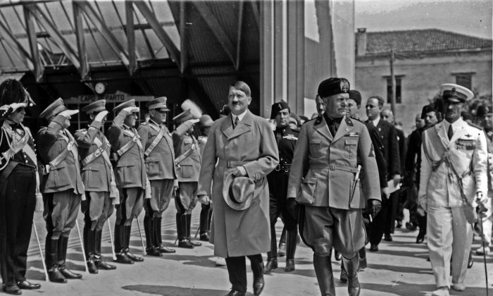 Adolf Hitler and Benito Mussolini walk in front of soldiers in Venice, Italy, in June 1934. (Istituto Nazionale Luce)