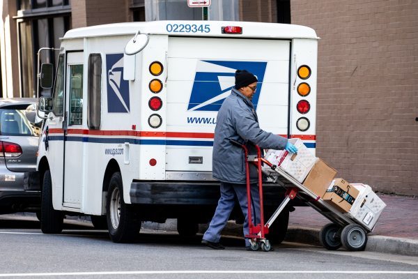 A woman unloads a USPS truck in Norfolk, Va., on Jan. 26, 2018. (Samira Bouaou/The Epoch Times)