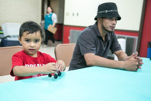 Hondurans Fidel Arcangel Gonsalez Meza, 26, and his 5-year-old son, at the Sacred Heart Church in McAllen, Texas, after corssing the border, on May 30, 2017. (Benjamin Chasteen/The Epoch Times)