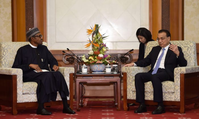 China's Premier Li Keqiang (R) talks to Nigeria's President Muhammadu Buhari during their meeting at the Diaoyutai State Guesthouse in Beijing on Sept. 5, 2018. (Parker Song/AFP/Getty Images)