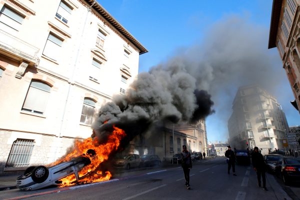 A burning car is seen
