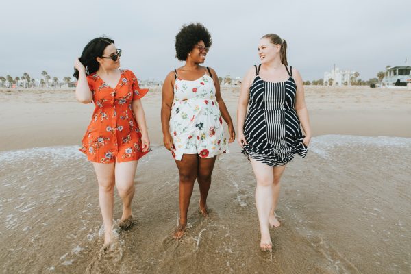 overweight women walking on beach