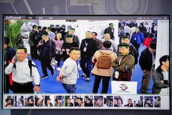 A screen shows visitors being filmed by artificial intelligence security cameras