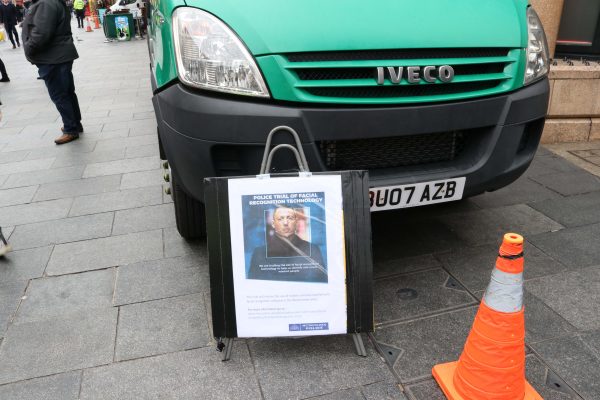 A sign informing the public that they will be scanned by facial recognition cameras