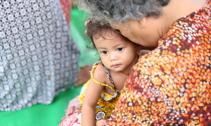 An unidentified woman holding a baby. 
(Cambodian Children’s Trust)