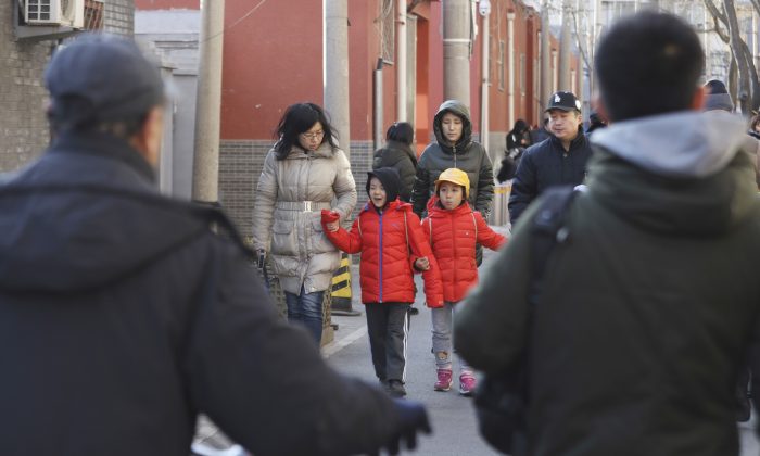 Children are escorted from the site of an attack at the  Beijing No. 1 Affiliated Elementary School of Xuanwu Normal School in Beijing on Jan. 8, 2019. A male attacker injured 20 children inside the primary school in China's capital, officials said. (Ng Han Guan/AP)