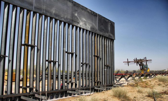 Workers are photographed during construction of approximately 20 miles of the border wall by order of President Donald Trump on the border between Ciudad Juarez, Chihuahua state, Mexico and Santa Teresa, New Mexico state, on April 17, 2018. (Herica Martinez/AFP/Getty Images)