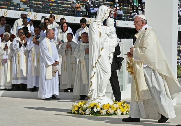 Pope Francis (R) leads mass