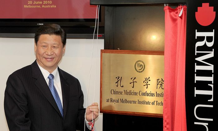 China's then-Vice President Xi Jinping (now Chinese leader) unveils a plaque at the opening of Australia's first Chinese Medicine Confucius Institute at the RMIT University in Melbourne on June 20, 2010. (William West/AFP/Getty Images)