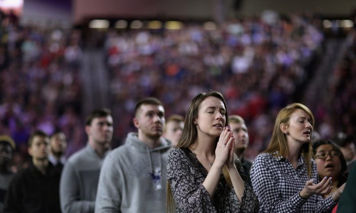 Thousands of students, supporters and invited guests sing songs of Christian praise before Republican presidential candidate Donald Trump delivers the convocation in the Vines Center on the campus of Liberty University  January 18, 2016 in Lynchburg, Virginia. Chip Somodevilla/Getty Images