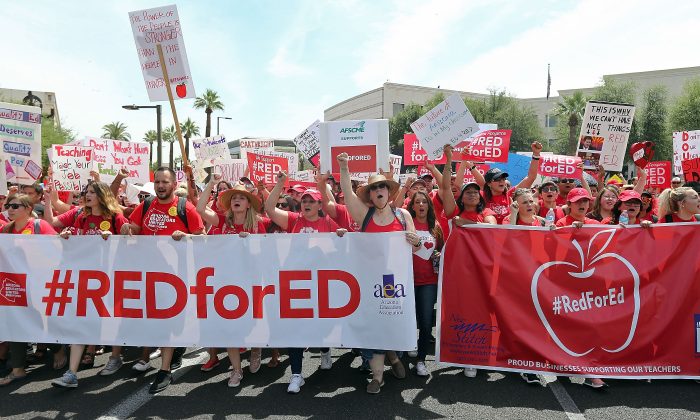 Arizona teachers march through downtown Phoenix on their way to the State Capitol as part of a rally for the #REDforED movement in Phoenix, Arizona on April 26, 2018. (Ralph Freso/Getty Images)