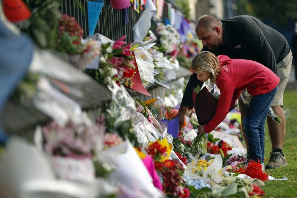 Mourners lay flowers