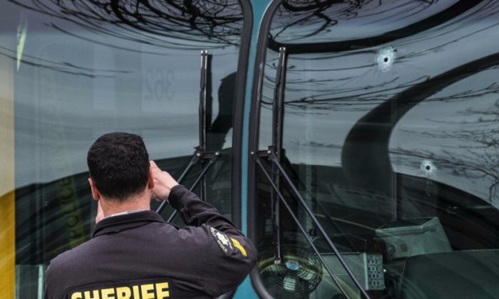 Several bullet holes can be seen in the driver's side window of a metro Bus after a shooting in beattle, on March 27, 2019. (Dean Rutz/The Seattle Times via AP)