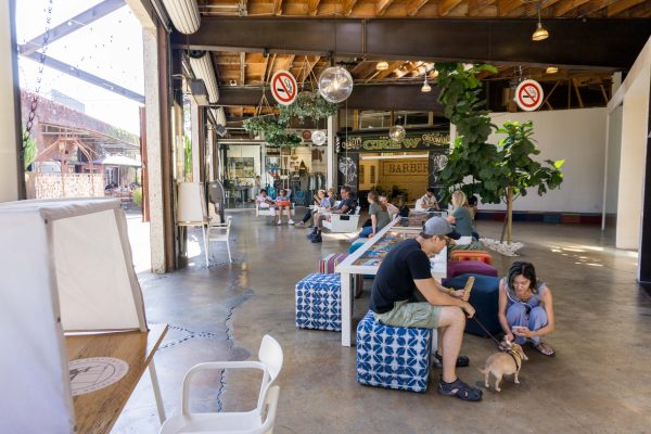 Shoppers relax on cushions and swinging benches at the lab