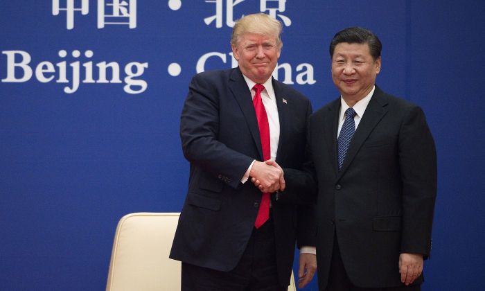 U.S. President Donald Trump and Chinese leader Xi Jinping shake hands during a business leaders event at the Great Hall of the People in Beijing on November 9, 2017. (NICOLAS ASFOURI/AFP/Getty Images)