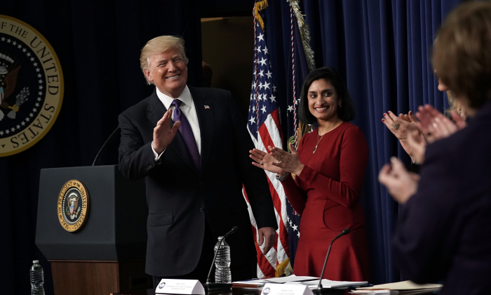 President Donald Trump (L) acknowledges the audience as Administrator of the Centers for Medicare and Medicaid Services Seema Verma (2nd L) looks on in the Eisenhower Executive Office Building in Washington on Jan. 18, 2018. (Alex Wong/Getty Images)