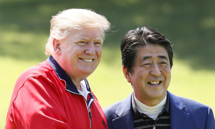 President Donald Trump (L) is welcomed by Japanese Prime Minister Shinzo Abe as he arrives to play golf at Mobara Country Club on May 26, 2019 in Chiba, Japan. (Kimimasa Mayama/Getty Images)