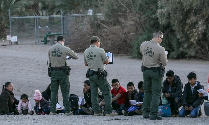 A group of illegal aliens is apprehended by Border Patrol after crossing from Mexico into Yuma, Ariz., on April 12, 2019. (Charlotte Cuthbertson/The Epoch Times)