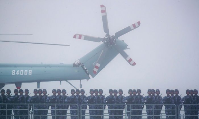 Chinese soldiers stand on the deck of transport dock Yimen Shan in the sea near Qingdao in Shandong province on April 23, 2019. (Mark Schiefelbein/AFP/Getty Images)