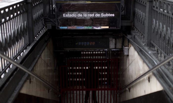 A subway employee stands in the closed entrance off Buenos Aires’s Subway during the blackout, in Buenos Aires, Argentina, Sunday, June 16, 2019. (Tomas F. Cuesta/AP Photo)