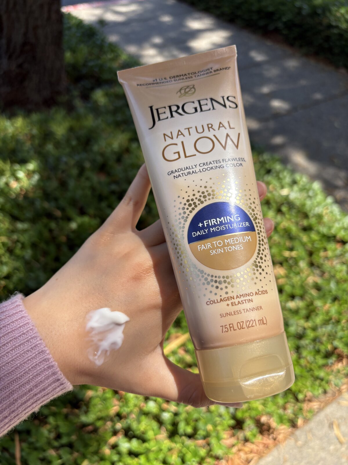 Jergens Natural Glow Gradual Tanning Lotion. Show in hand with a swatch